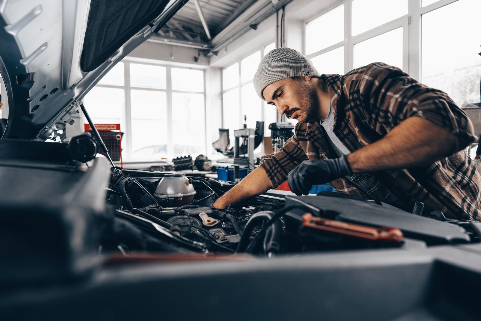 Technician performing car air conditioning repair in an Al Quoz workshop