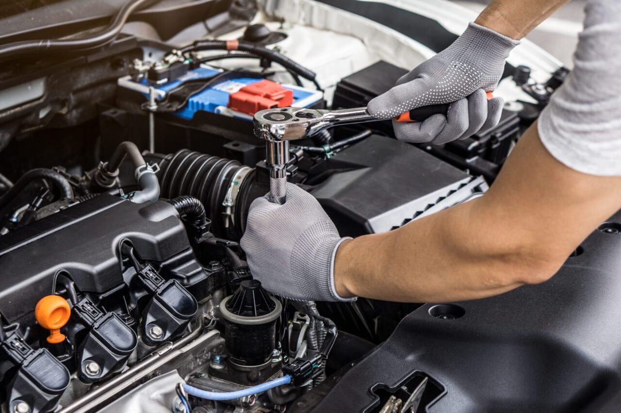 Mechanic inspecting a vehicle during car AC repair in a Dubai workshop