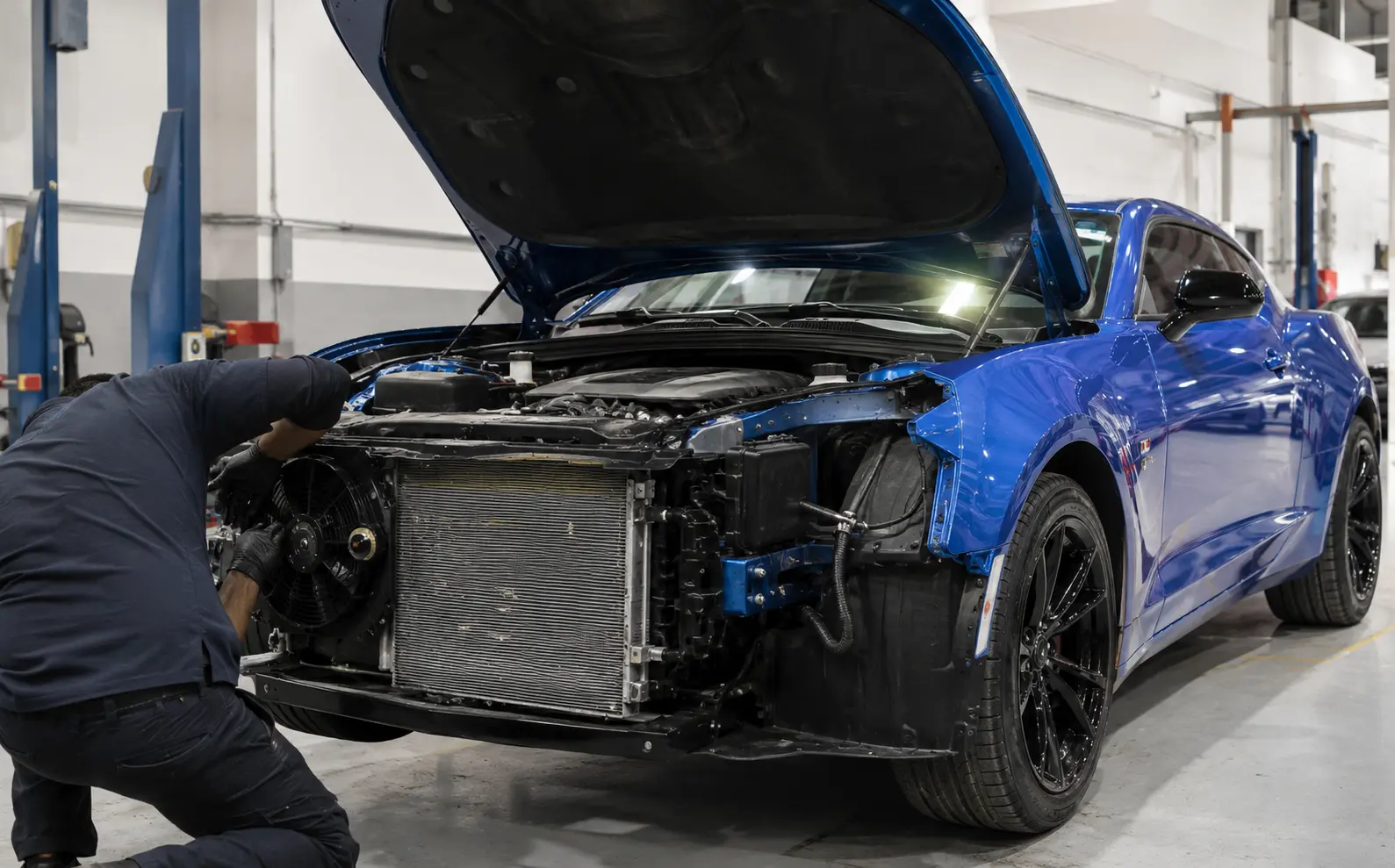 Blue Chevrolet Camaro AC inspection in a Dubai workshop