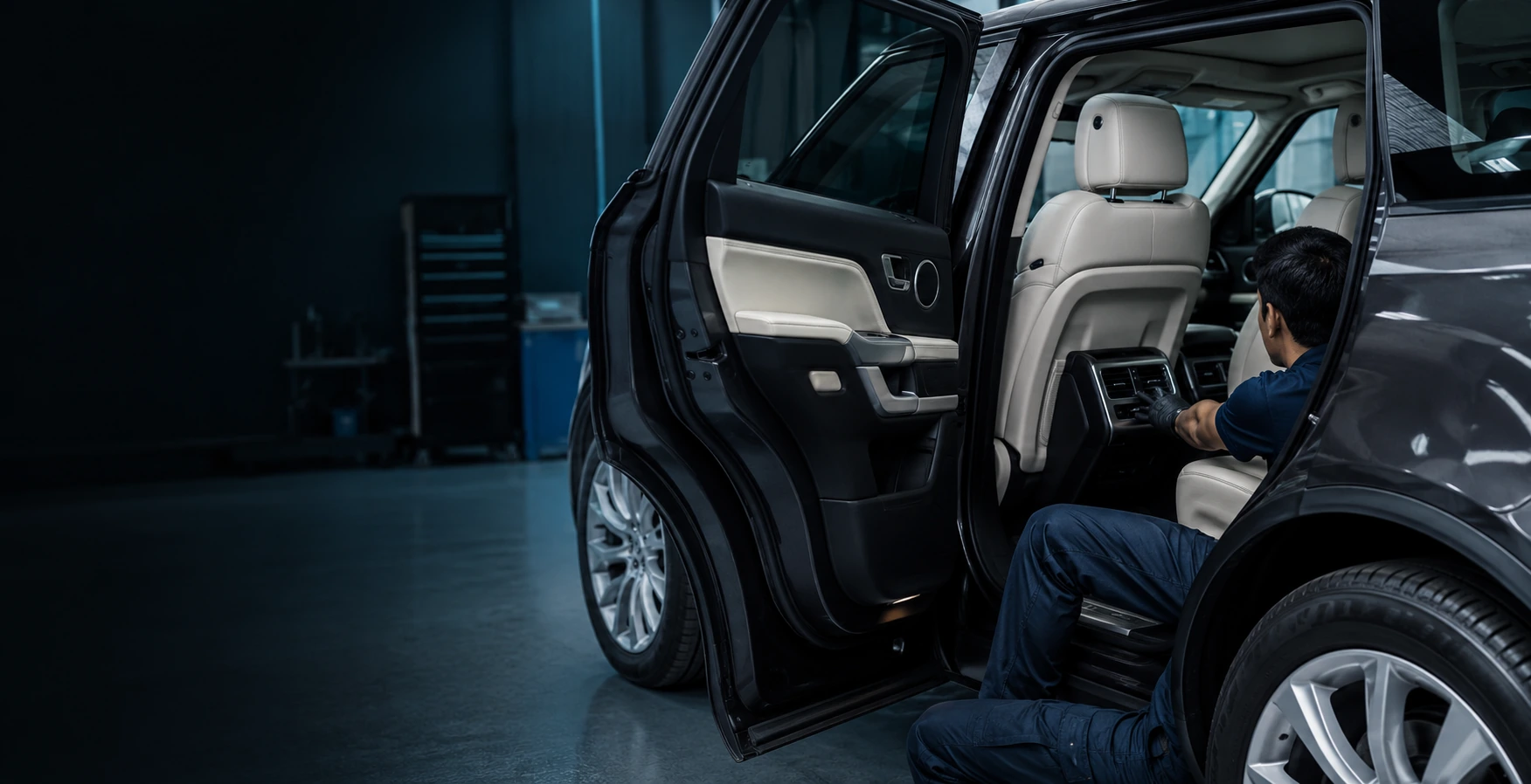 Technician checking rear SUV AC vent temperature and airflow